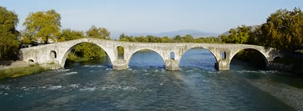 The stone Bridge of Arta spanning the Arachthos River, with its uneven semicircular arches of Byzantine and Ottoman construction
