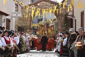 Modern procession through the Byzantine arched gateway to Saint Theodora church in Arta, Greece