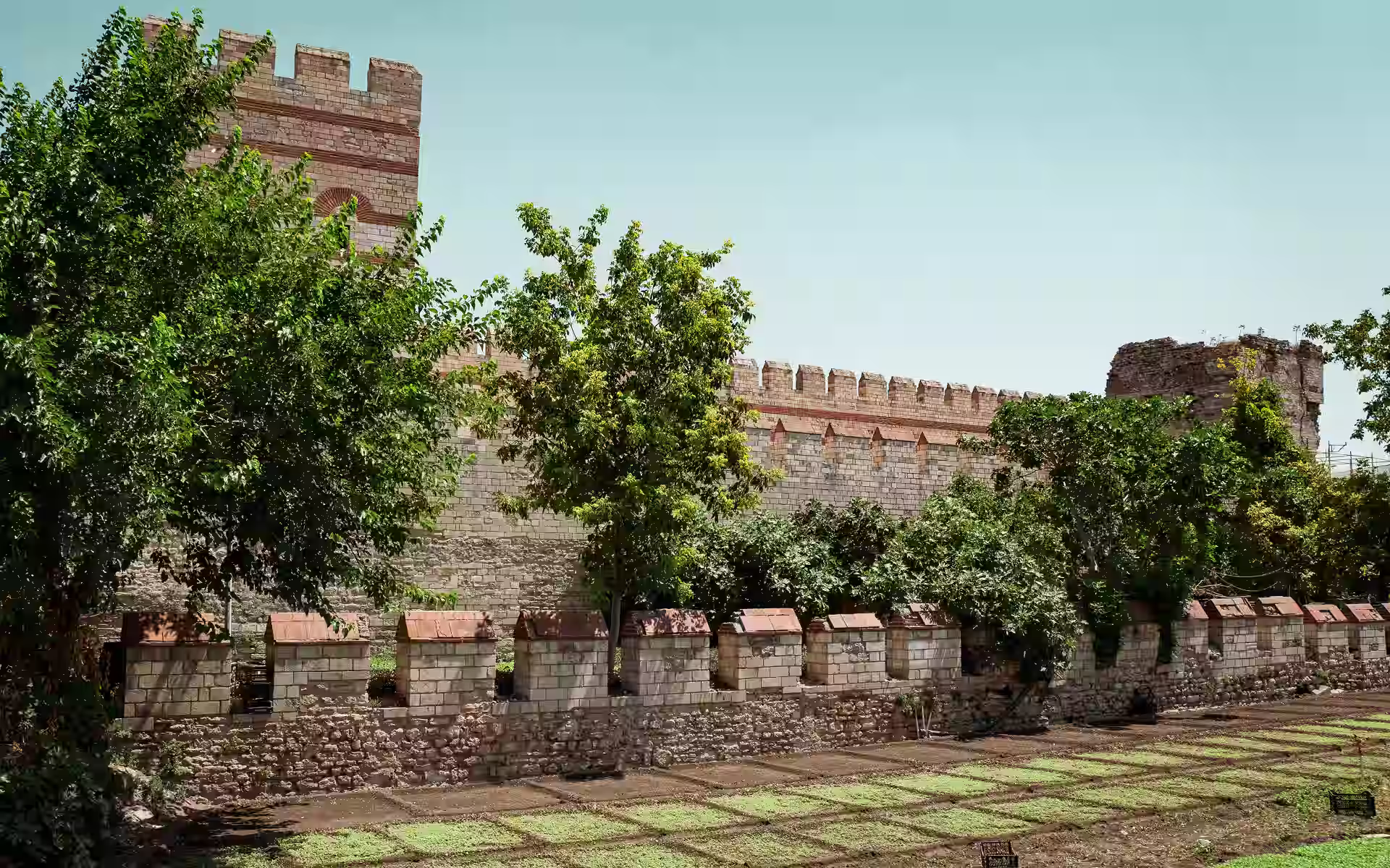 The ruined triple Theodosian Walls of Constantinople in Istanbul, the 5th-century Byzantine land fortifications with towers and moat